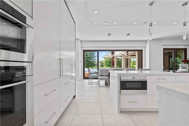 10712 W 165th St, Overland Park, KS 66221 - kitchen featuring modern cabinets, white cabinets, light countertops, light tile patterned floors, and healthy amount of natural light