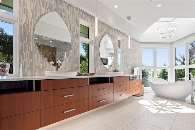 10712 W 165th St, Overland Park, KS 66221 - full bath featuring double vanity, a freestanding bath, tile patterned floors, and a shower
