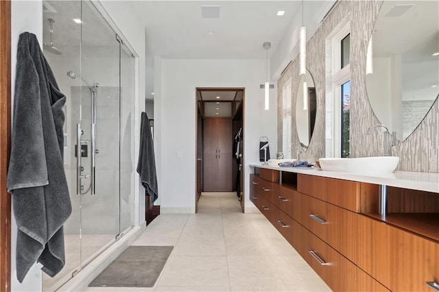 10712 W 165th St, Overland Park, KS 66221 - bathroom with double vanity, a stall shower, tile patterned flooring, and baseboards