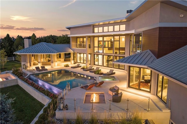 10712 W 165th St, Overland Park, KS 66221 - view of pool featuring an outdoor living space with a fire pit, a patio, and a pool with connected hot tub