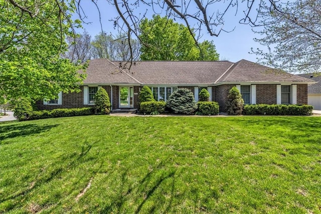 single story home with a front lawn and brick siding