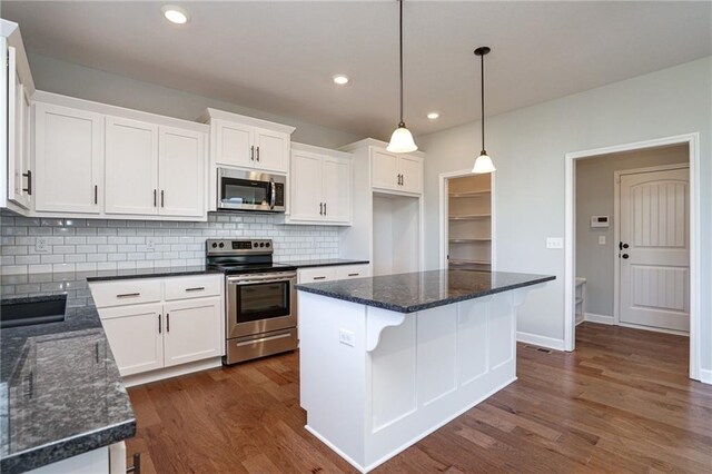 18256 W 166th St, Olathe, KS 66062 - kitchen with appliances with stainless steel finishes, white cabinets, backsplash, dark wood-style floors, and recessed lighting