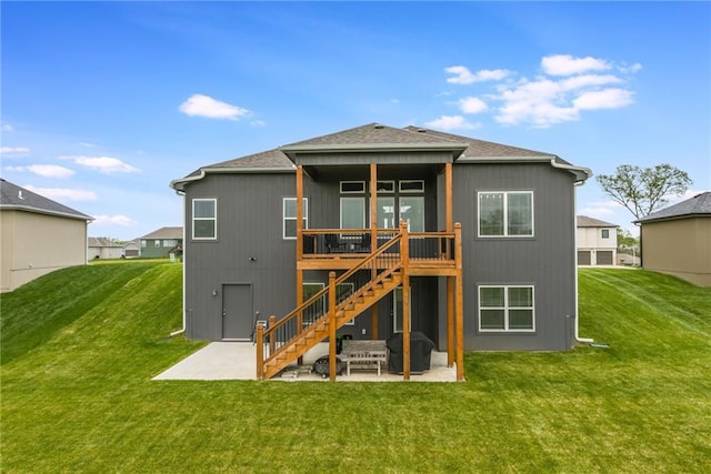 back of house featuring a lawn, a patio, a wooden deck, and stairs