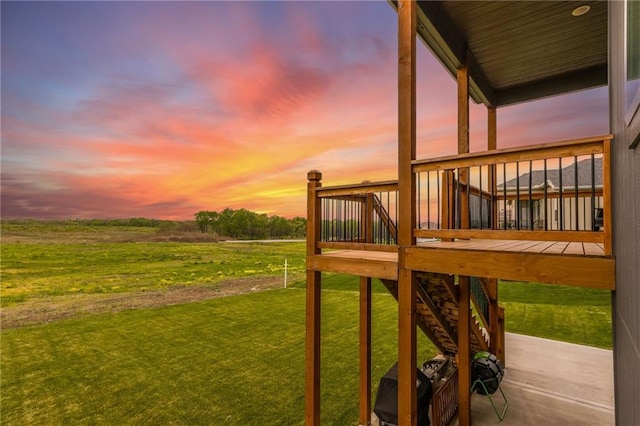 yard at dusk featuring a deck