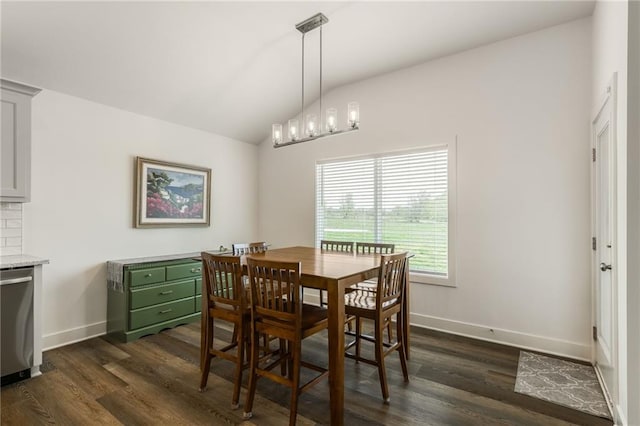 dining area with baseboards, vaulted ceiling, and dark wood finished floors