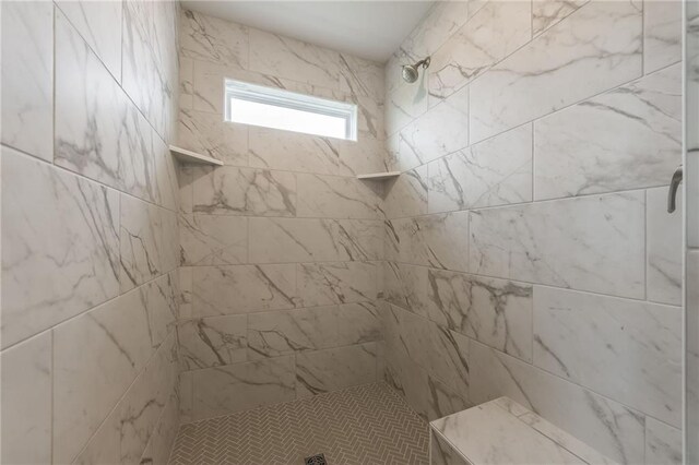full bathroom with tiled shower
