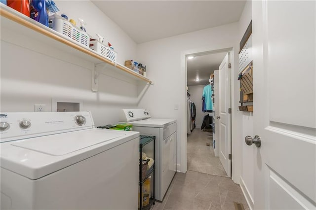 washroom with light tile patterned floors, laundry area, and independent washer and dryer