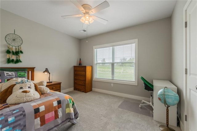 carpeted bedroom with baseboards and a ceiling fan