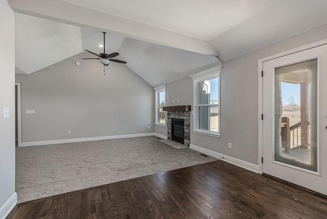 unfurnished living room featuring lofted ceiling, a ceiling fan, dark wood-type flooring, baseboards, and a fireplace