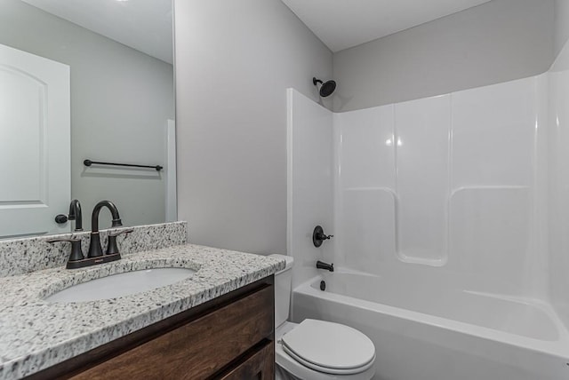 bathroom featuring bathtub / shower combination, vanity, and toilet