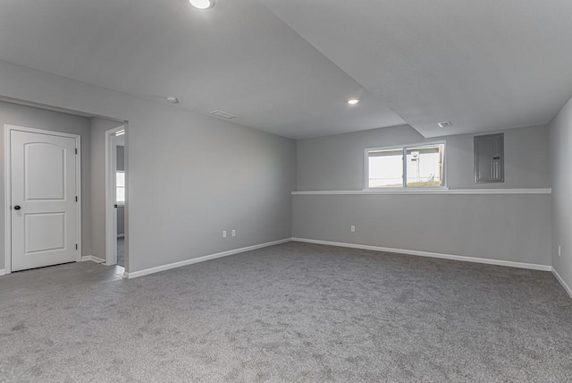 carpeted spare room featuring baseboards, visible vents, electric panel, and recessed lighting