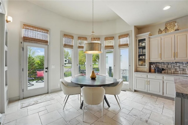 dining space featuring stone tile floors, recessed lighting, and a healthy amount of sunlight