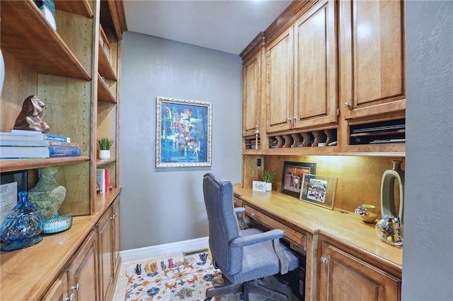 office space featuring built in study area and baseboards