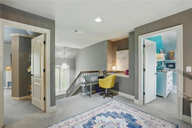 office space with visible vents, carpet floors, lofted ceiling, baseboards, and built in study area
