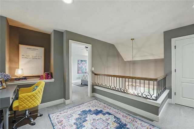 office space with baseboards, vaulted ceiling, and carpet