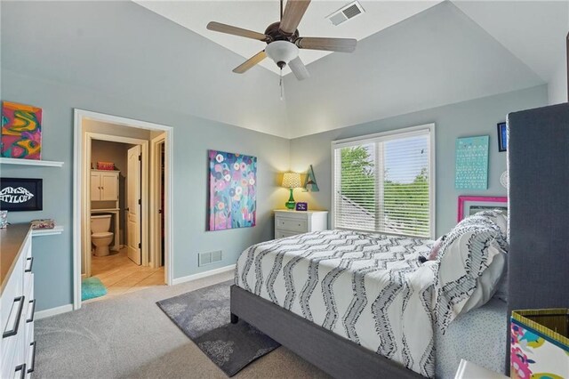 bedroom featuring light colored carpet, baseboards, visible vents, and lofted ceiling