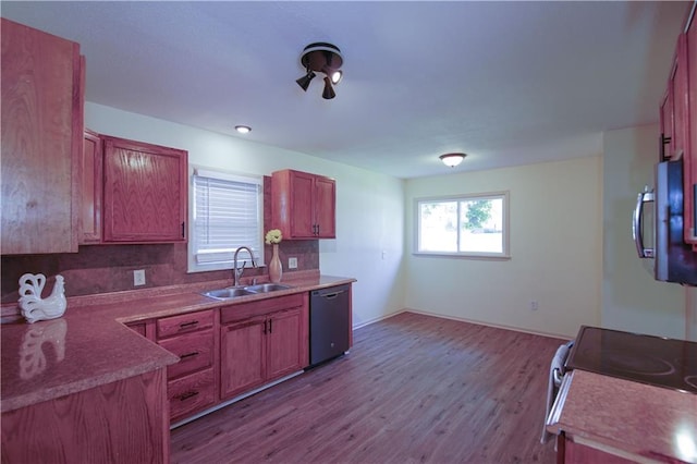 502 W Broadway St, Higginsville, MO 64037 - kitchen with a sink, dishwasher, wood finished floors, backsplash, and stainless steel microwave