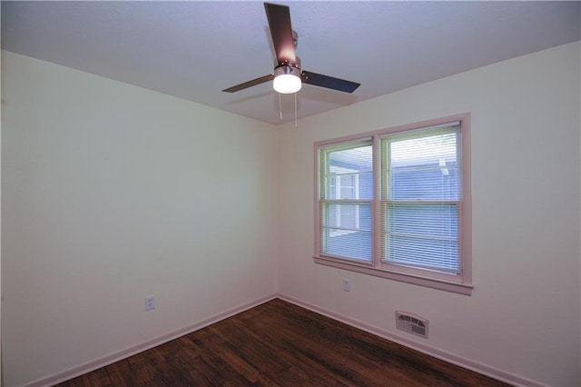 502 W Broadway St, Higginsville, MO 64037 - spare room with dark wood-style floors, baseboards, and a ceiling fan