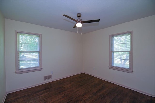 502 W Broadway St, Higginsville, MO 64037 - spare room featuring dark wood-style floors, ceiling fan, and baseboards