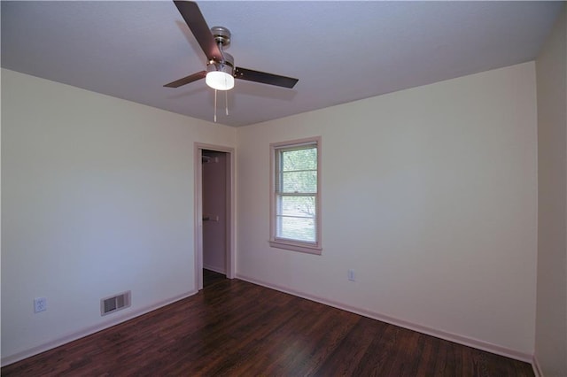 502 W Broadway St, Higginsville, MO 64037 - unfurnished room with dark wood-style floors, ceiling fan, and baseboards