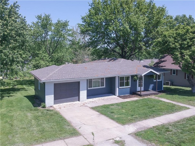 502 W Broadway St, Higginsville, MO 64037 - ranch-style house featuring an attached garage, a front yard, driveway, a shingled roof, and central air condition unit
