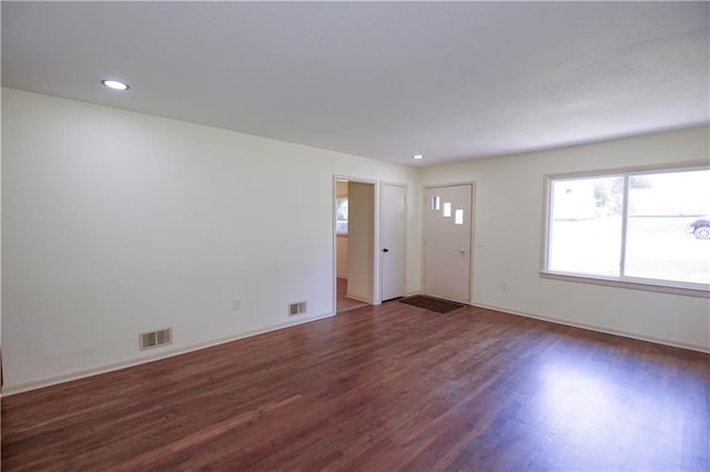 502 W Broadway St, Higginsville, MO 64037 - unfurnished living room featuring plenty of natural light, wood finished floors, recessed lighting, and baseboards