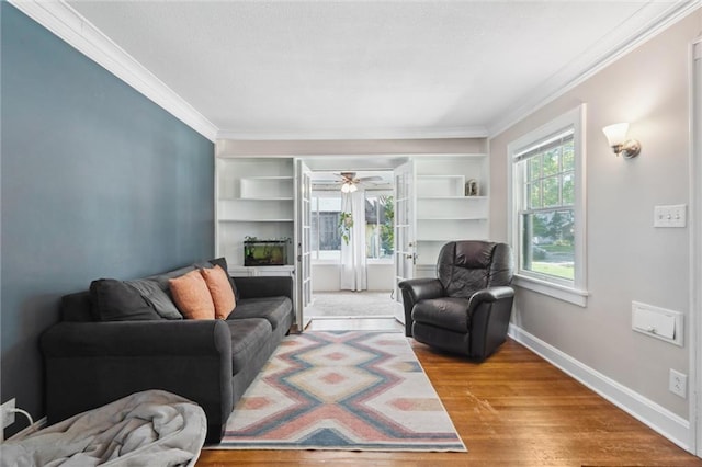 7227 Jefferson St, Kansas City, MO 64114 - living room featuring crown molding, wood finished floors, baseboards, and a ceiling fan