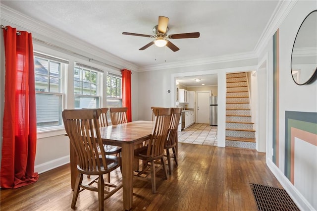 7227 Jefferson St, Kansas City, MO 64114 - dining room with hardwood / wood-style floors, ceiling fan, stairway, baseboards, and ornamental molding