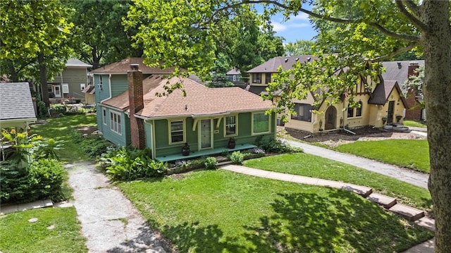 7227 Jefferson St, Kansas City, MO 64114 - view of front of property with a front lawn, a chimney, and a porch