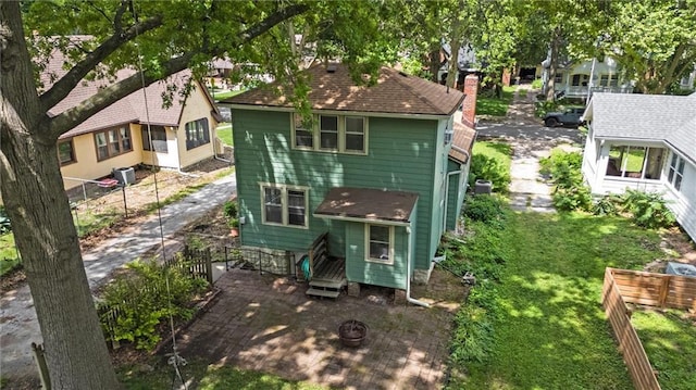 7227 Jefferson St, Kansas City, MO 64114 - rear view of property with a chimney and a fire pit