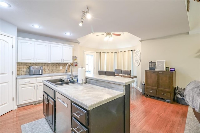 1215 Nottingham Dr, Warrensburg, MO 64093 - kitchen featuring ceiling fan, light countertops, white cabinetry, a sink, and light wood finished floors