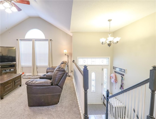 1215 Nottingham Dr, Warrensburg, MO 64093 - foyer entrance with light colored carpet, lofted ceiling, and ceiling fan with notable chandelier