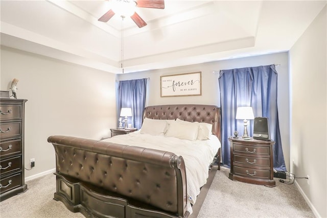 1215 Nottingham Dr, Warrensburg, MO 64093 - carpeted bedroom featuring a raised ceiling, baseboards, and ceiling fan