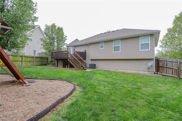 1215 Nottingham Dr, Warrensburg, MO 64093 - rear view of property with a fenced backyard, a deck, central AC, and stairway