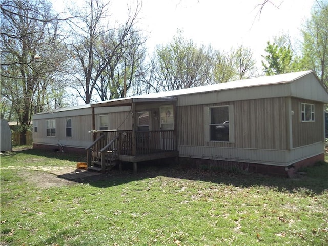 rear view of house with a yard
