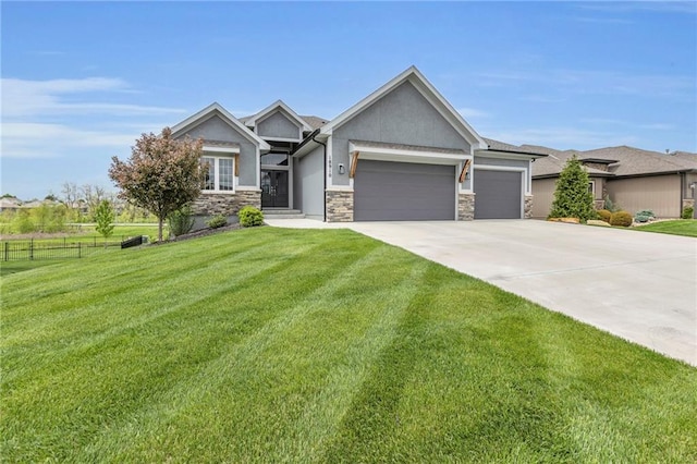 craftsman-style home featuring a garage, stucco siding, driveway, and a front yard