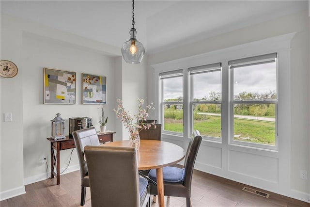 dining room with baseboards, dark wood-type flooring, and visible vents