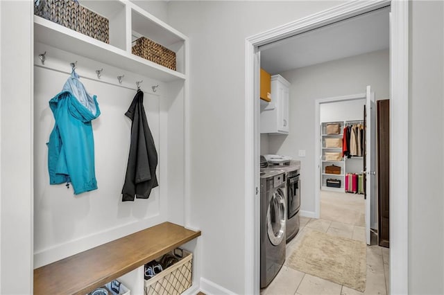 mudroom featuring baseboards and washer and clothes dryer