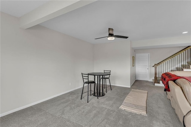 dining space with stairway, baseboards, ceiling fan, and carpet flooring