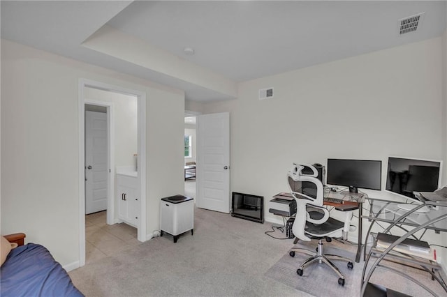 carpeted home office with baseboards and visible vents