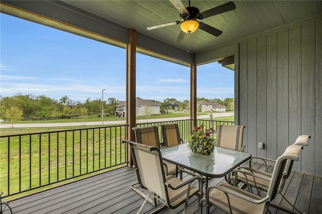sunroom featuring outdoor dining space and ceiling fan