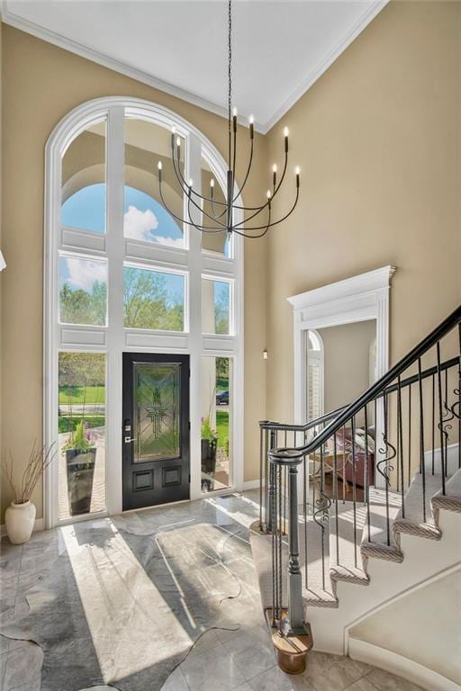 9705 Sunset Cir, Lenexa, KS 66220 - foyer entrance featuring stairs, a notable chandelier, crown molding, and a towering ceiling