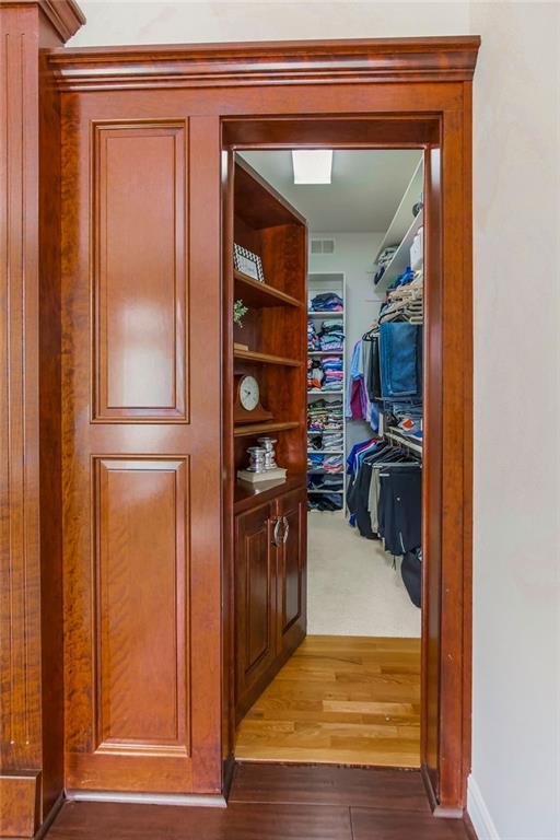 9705 Sunset Cir, Lenexa, KS 66220 - walk in closet with wood finished floors