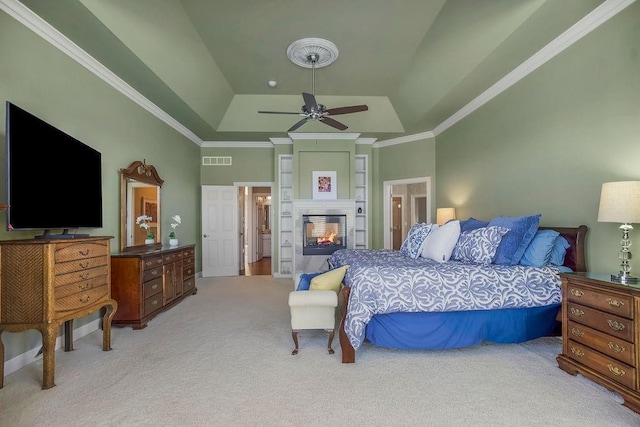 9705 Sunset Cir, Lenexa, KS 66220 - carpeted bedroom featuring a raised ceiling, visible vents, a multi sided fireplace, ceiling fan, and ornamental molding