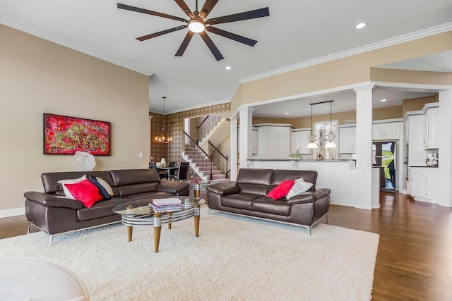 9705 Sunset Cir, Lenexa, KS 66220 - living area featuring stairway, ceiling fan with notable chandelier, ornate columns, dark wood-style flooring, and recessed lighting
