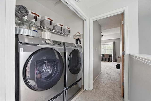 clothes washing area featuring washing machine and clothes dryer and carpet