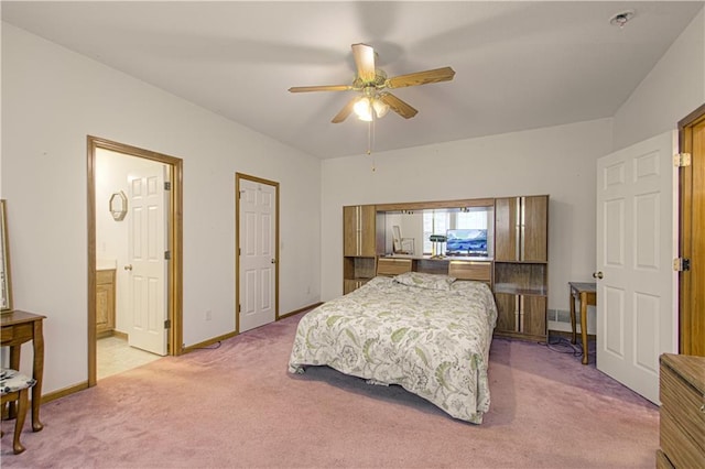 bedroom featuring ensuite bath, ceiling fan, light colored carpet, and baseboards