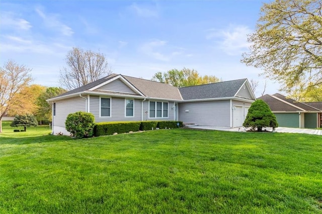ranch-style home featuring an attached garage and a front yard