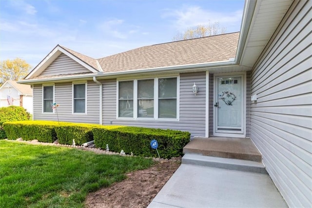 property entrance with a shingled roof