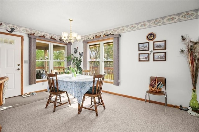 dining room featuring a wealth of natural light, baseboards, carpet floors, and a notable chandelier